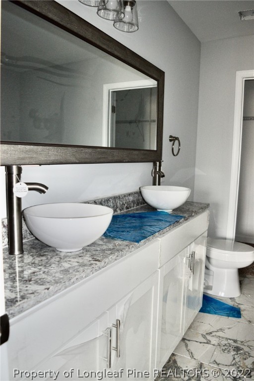263 McMillan Siding Road Parkton, NC 28371 - Photo 10 of 15 a bathroom with a granite countertop sink and a mirror