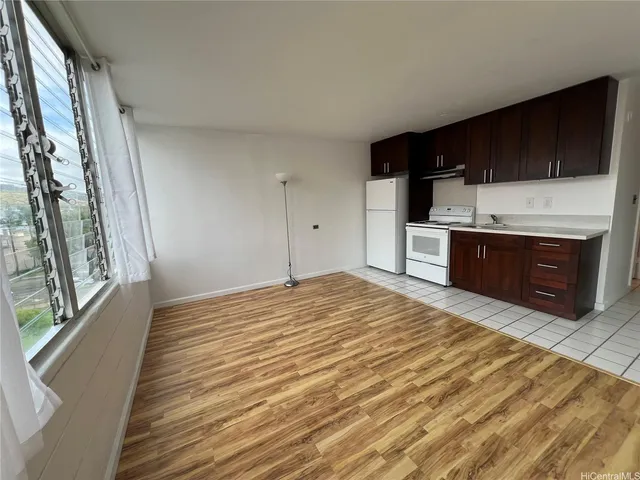 a kitchen with a stove top oven and sink
