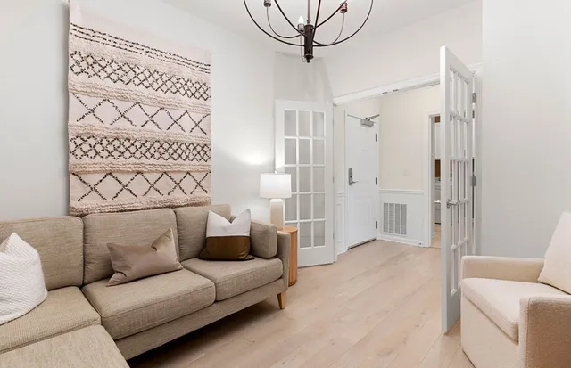 a bedroom with a bed and a chandelier