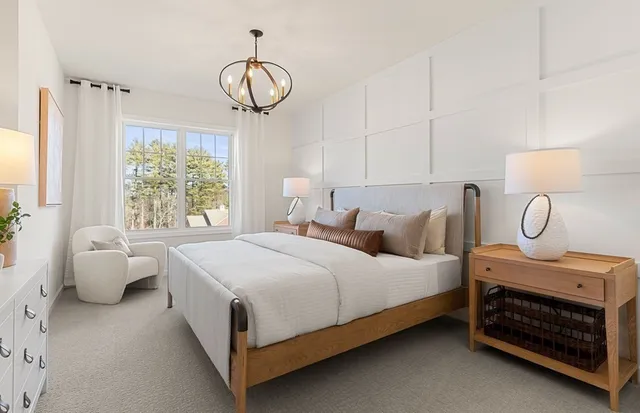 a bedroom with a bed a mirror and lamp