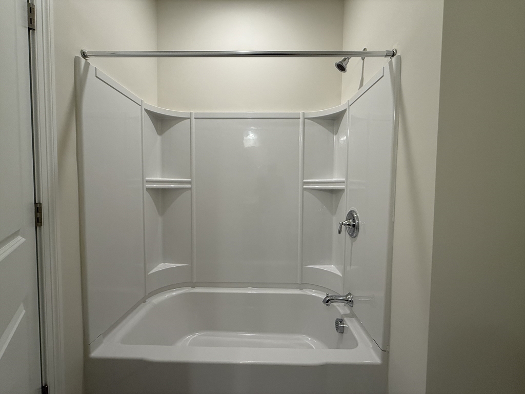 4 Winslow Lane, Unit 1411 North Grafton, MA 01536 - Photo 26 of 36 a bathroom with a shower and a bath tub