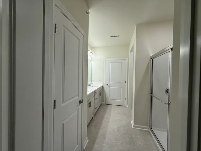 a bathroom with a double vanity sink and a mirror