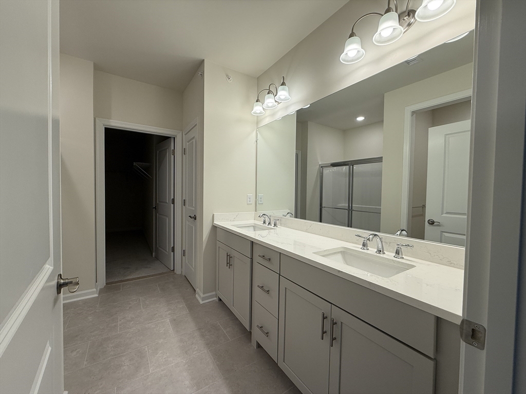 4 Winslow Lane, Unit 1411 North Grafton, MA 01536 - Photo 30 of 36 a bathroom with a double vanity sink and a mirror