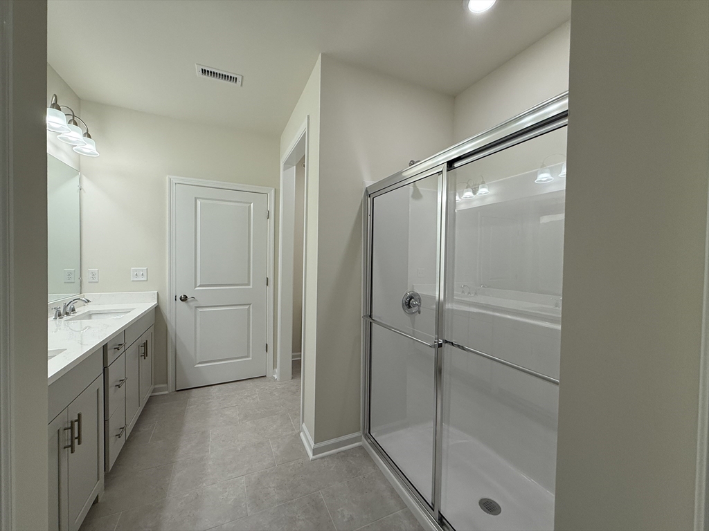 4 Winslow Lane, Unit 1411 North Grafton, MA 01536 - Photo 32 of 36 a bathroom with a shower and a sink