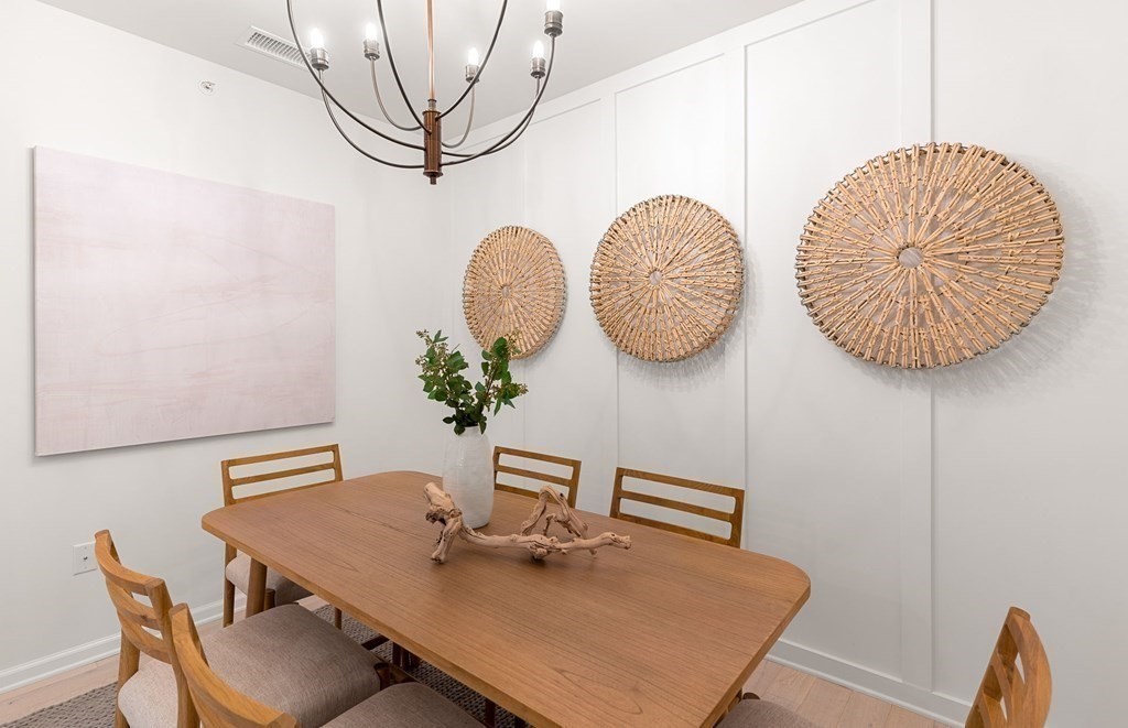 4 Winslow Lane, Unit 1411 North Grafton, MA 01536 - Photo 7 of 36 a table with chairs and wooden floor