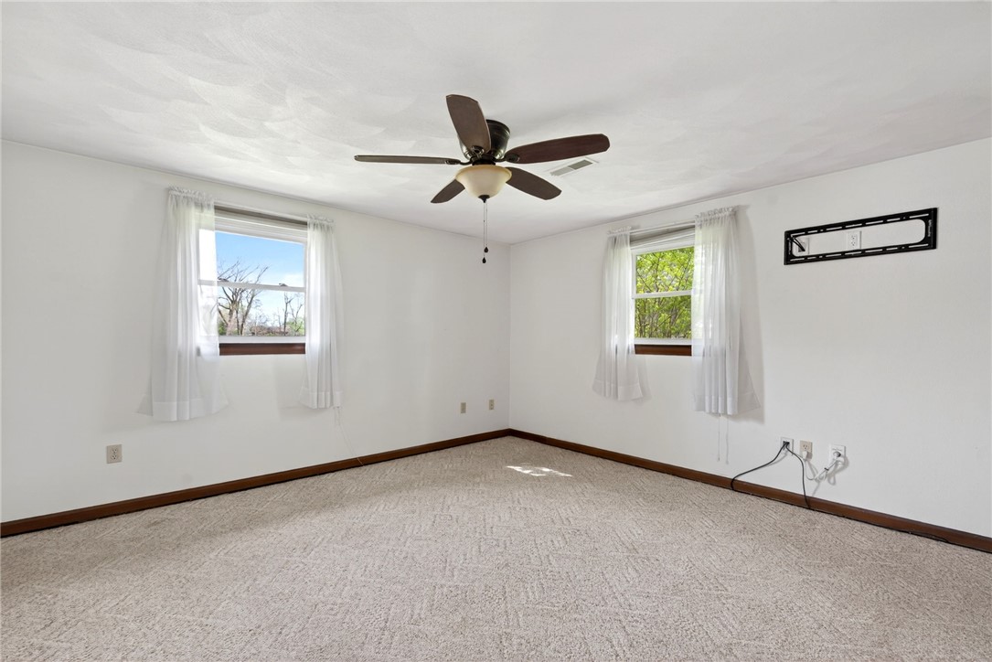 7988 McCool Road Greenville, OH 45331 - Photo 20 of 50 This bright room features abundant natural light and carpet flooring.