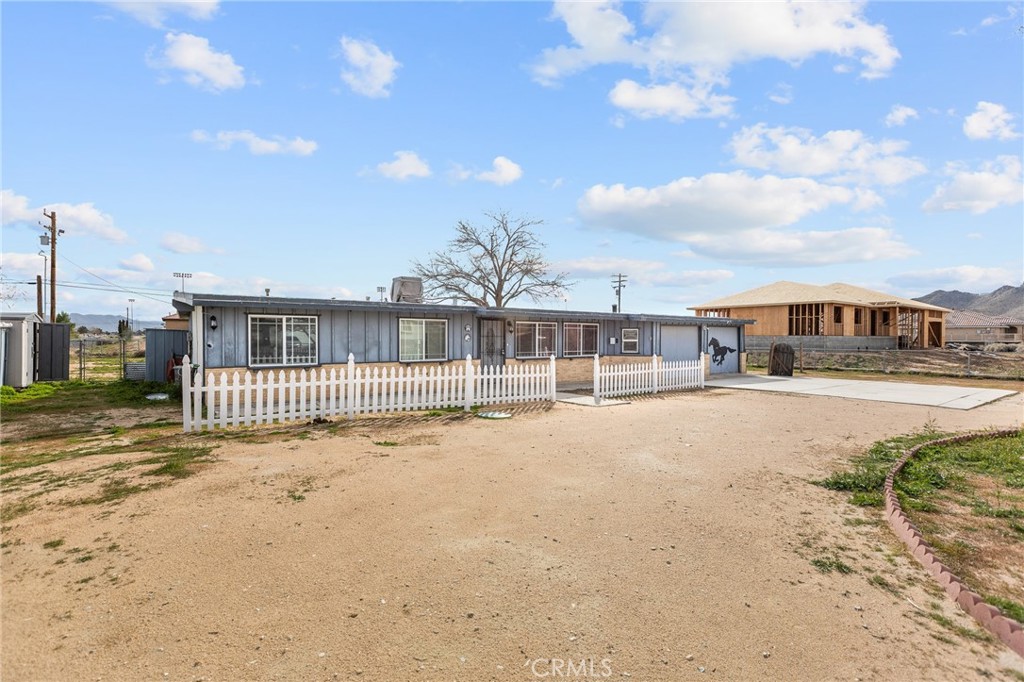 21103 Wigwam Road Apple Valley, CA 92307 - Photo 1 of 1 a view of swimming pool with large trees and buildings in the background