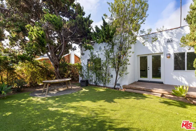 a view of a swimming pool with a bench and some trees