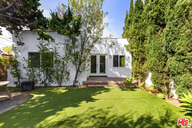 a view of a house with a tree and plants