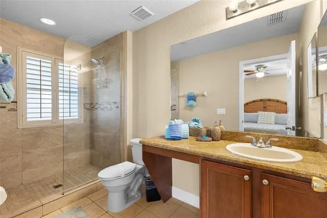 a bathroom with a sink toilet double vanity and shower