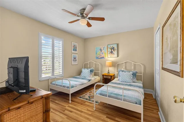 a bedroom with two beds and a window