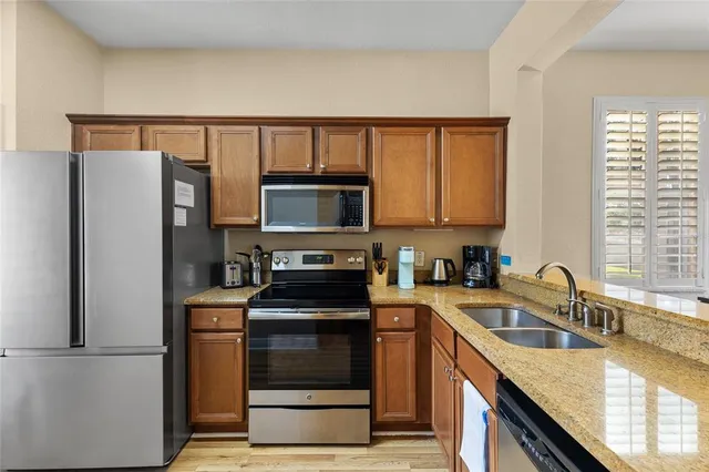 a kitchen with a refrigerator sink and microwave