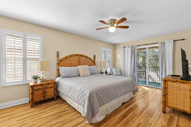 a bedroom with a bed a flat screen tv and dresser