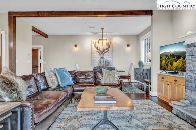 a living room with furniture and a chandelier