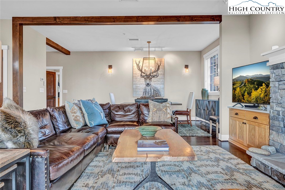 188 Ramblestone Terrace, Unit 101 Boone, NC 28607 - Photo 11 of 48 a living room with furniture and a chandelier