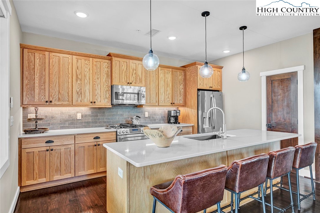 188 Ramblestone Terrace, Unit 101 Boone, NC 28607 - Photo 14 of 48 a kitchen with a table chairs sink and cabinets