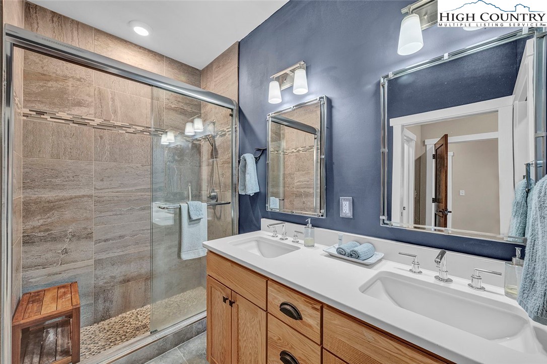 188 Ramblestone Terrace, Unit 101 Boone, NC 28607 - Photo 23 of 48 a bathroom with a double vanity sink mirror and shower