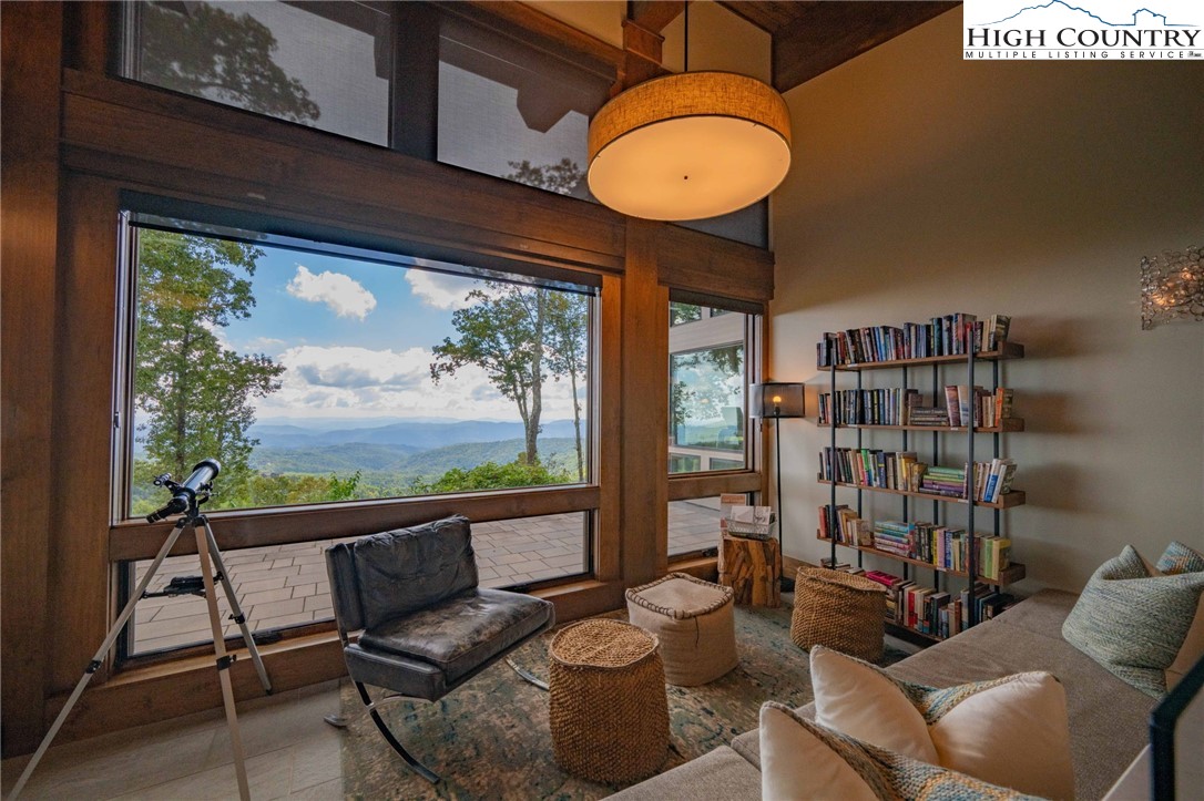 188 Ramblestone Terrace, Unit 101 Boone, NC 28607 - Photo 36 of 48 a living room with furniture and a floor to ceiling window