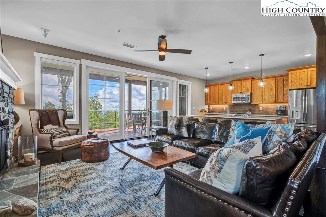 188 Ramblestone Terrace, Unit 101 Boone, NC 28607 - Photo 10 of 48 a living room with furniture kitchen view and a large window