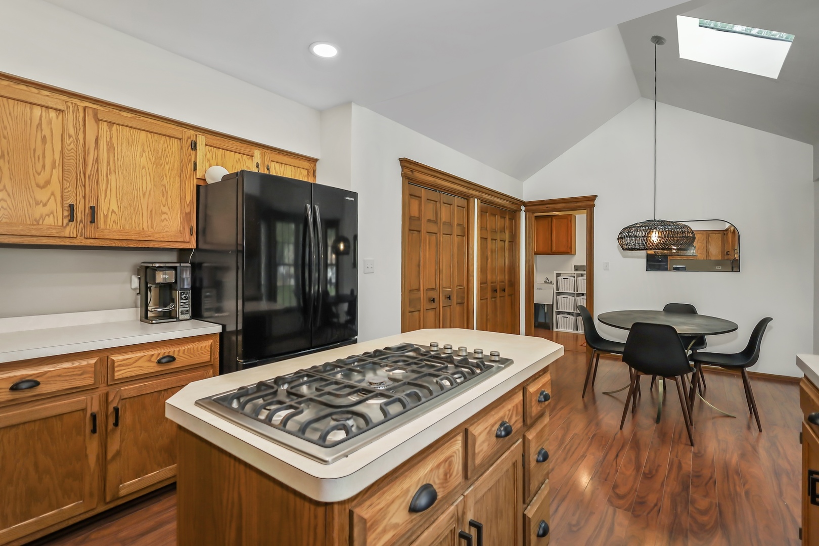 1091 Danforth Drive Batavia, IL 60510 - Photo 13 of 40 a kitchen with stainless steel appliances granite countertop a stove top oven a refrigerator a dining table and chairs with wooden floor