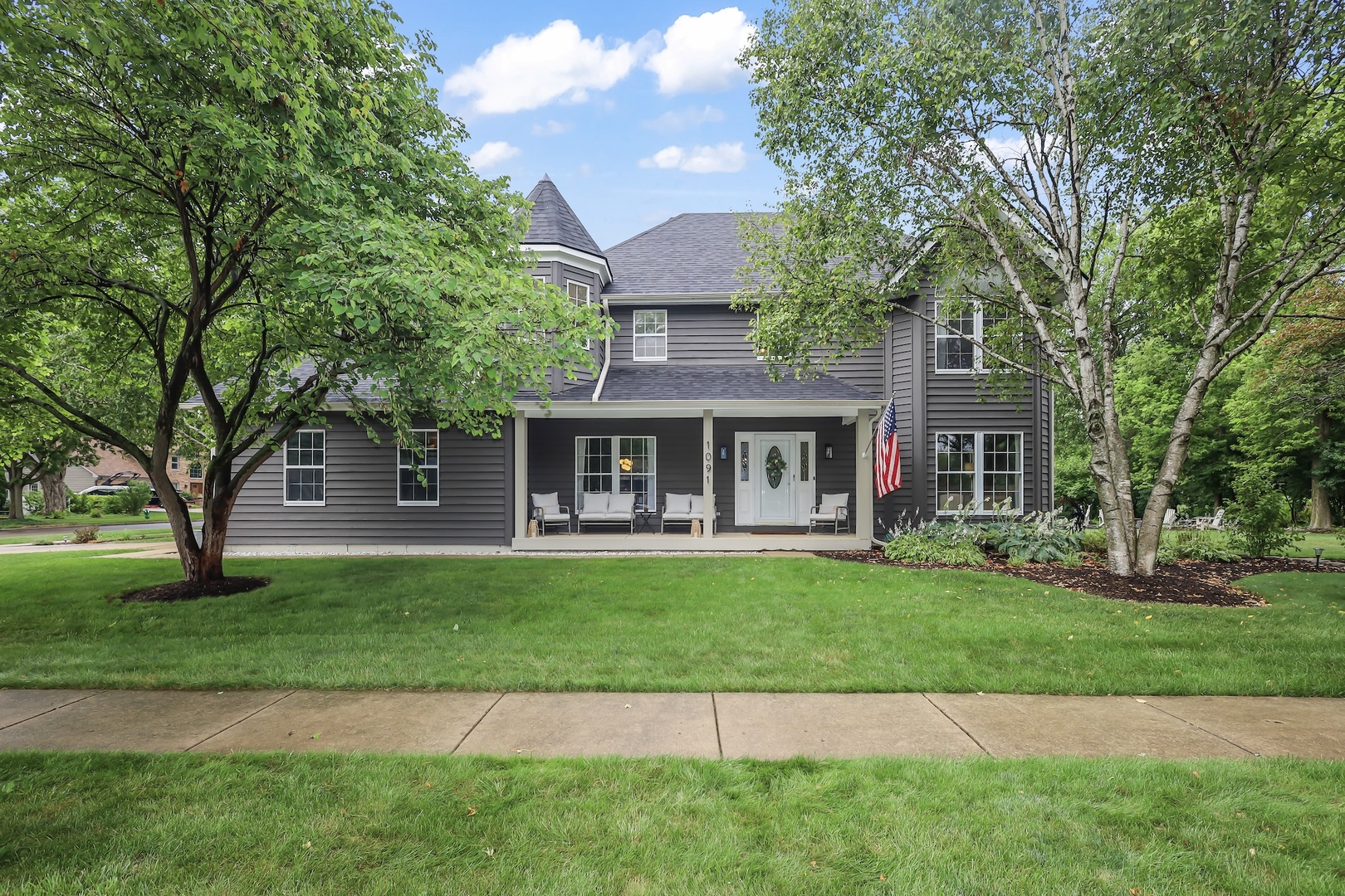 1091 Danforth Drive Batavia, IL 60510 - Photo 2 of 40 a front view of a house with a garden