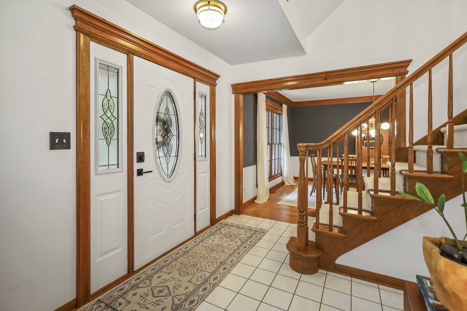 1091 Danforth Drive Batavia, IL 60510 - Photo 3 of 40 a view of a hallway with wooden floor and staircase