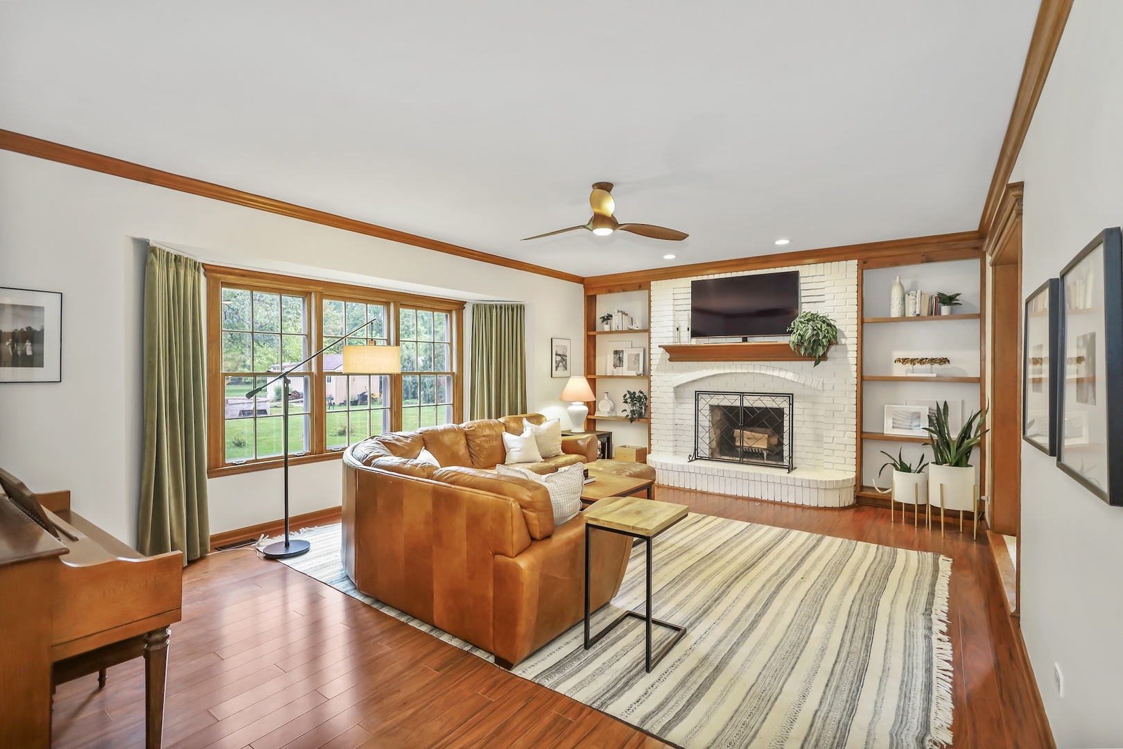 1091 Danforth Drive Batavia, IL 60510 - Photo 10 of 40 a living room with furniture a fireplace and a floor to ceiling window
