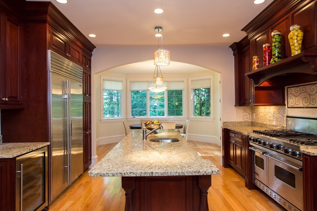 41 Cutler Lane Brookline, MA 02467 - Photo 4 of 12 a kitchen with stainless steel appliances granite countertop a stove a sink and a microwave