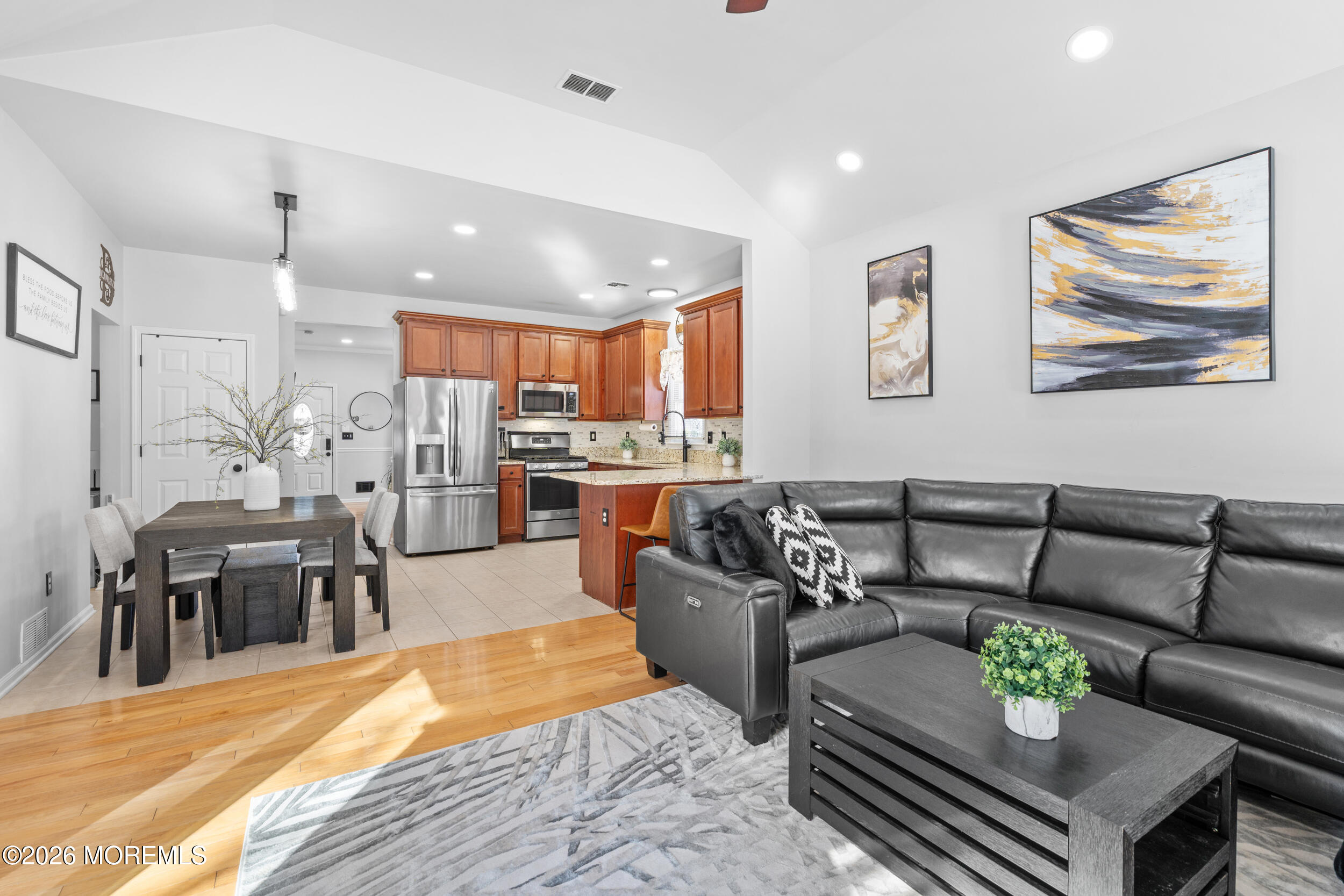 a living room with furniture and kitchen view