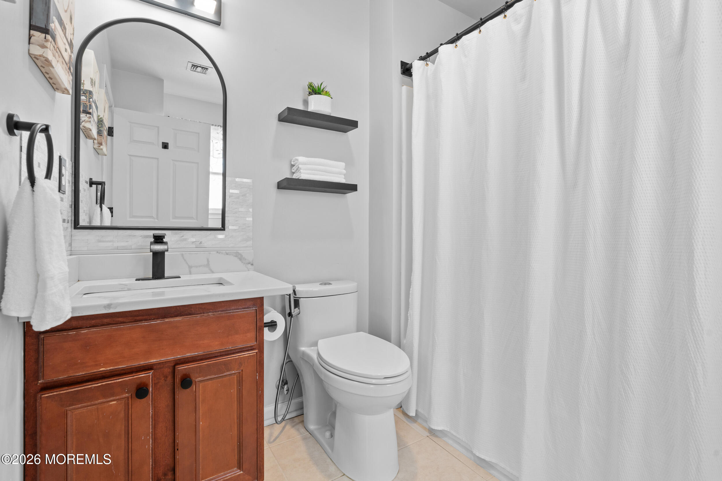 207 Lower Main Street Matawan, NJ 07747 - Photo 16 of 19 a bathroom with a sink a toilet and shower