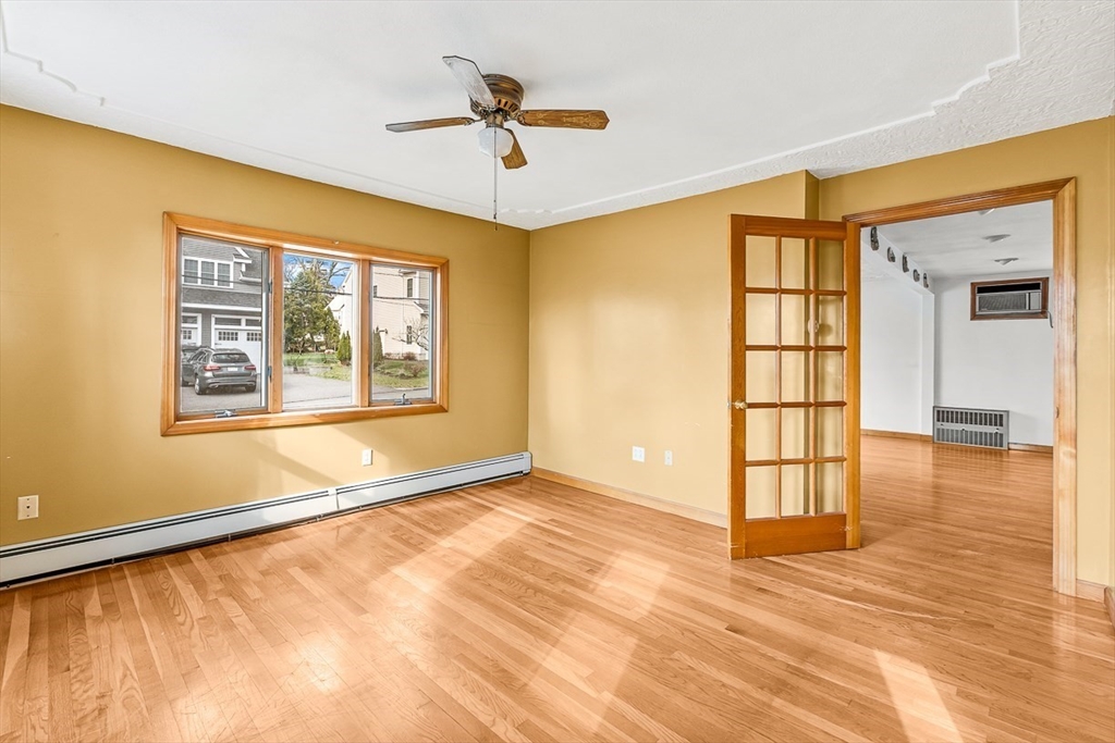 15 Tremont Street Stoneham, MA 02180 - Photo 14 of 38 a view of an empty room with window and wooden floor