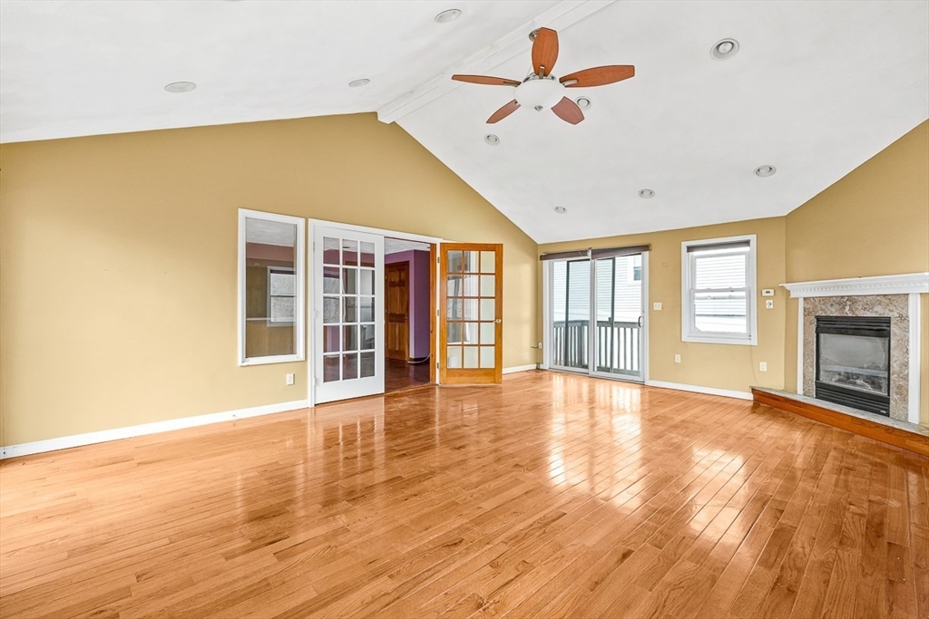 15 Tremont Street Stoneham, MA 02180 - Photo 23 of 38 a view of an empty room with a window and wooden floor