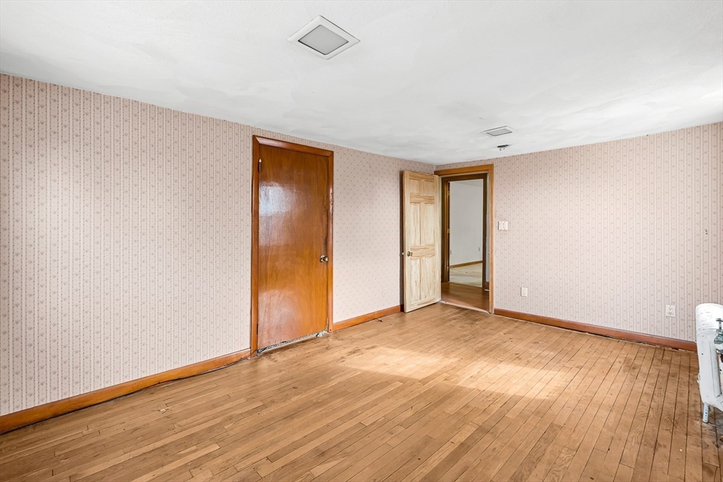 15 Tremont Street Stoneham, MA 02180 - Photo 26 of 38 an empty room with wooden floor and closet