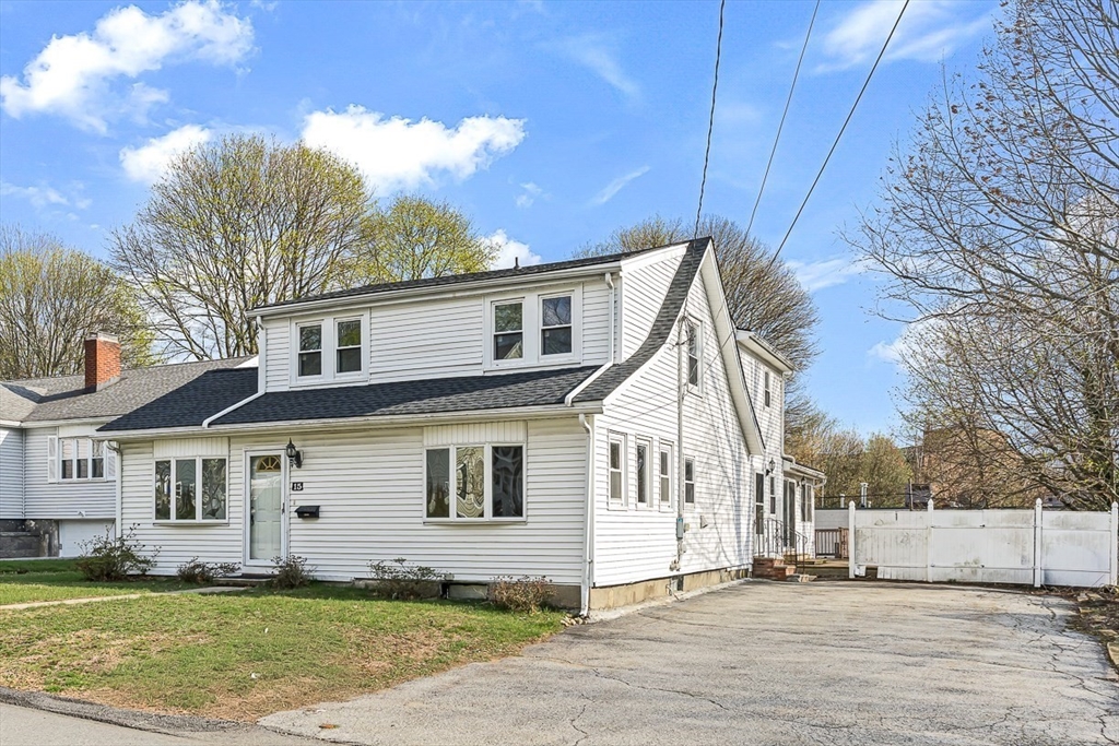 15 Tremont Street Stoneham, MA 02180 - Photo 3 of 38 a view of a white house with a big yard and large trees