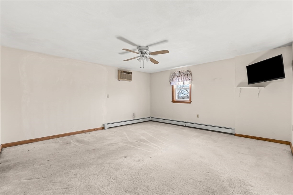 15 Tremont Street Stoneham, MA 02180 - Photo 31 of 38 an empty room with windows and fan