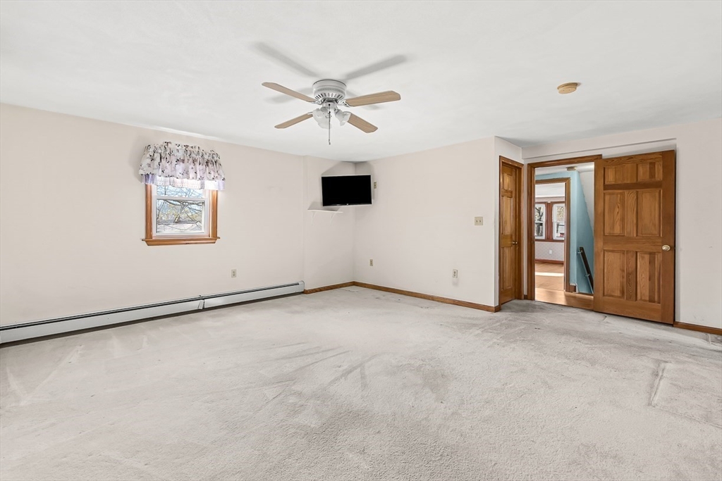 15 Tremont Street Stoneham, MA 02180 - Photo 32 of 38 an empty room with windows and closet