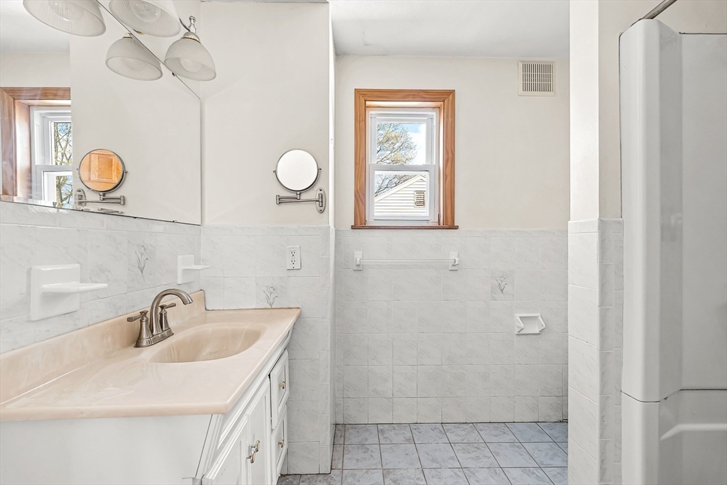 15 Tremont Street Stoneham, MA 02180 - Photo 34 of 38 a bathroom with a sink and a mirror