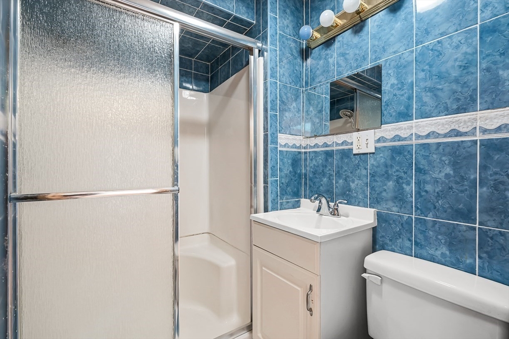 15 Tremont Street Stoneham, MA 02180 - Photo 35 of 38 a bathroom with a sink toilet and shower