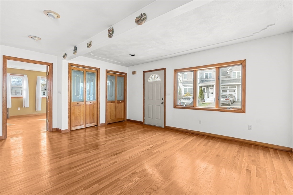 15 Tremont Street Stoneham, MA 02180 - Photo 6 of 38 an empty room with wooden floor and windows