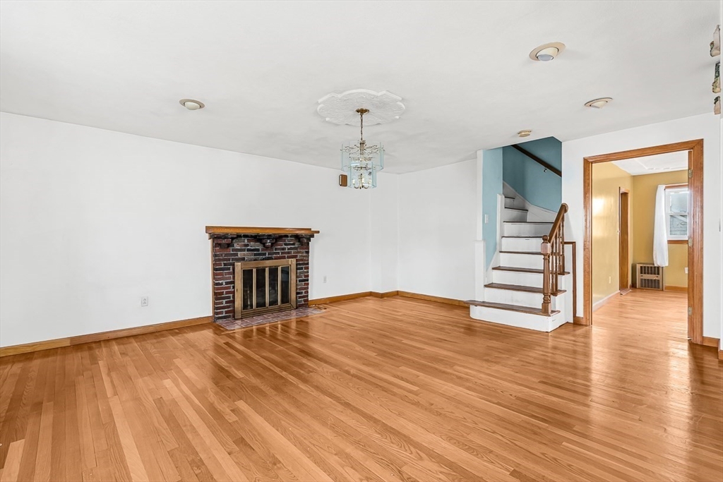 15 Tremont Street Stoneham, MA 02180 - Photo 9 of 38 a view of an empty room with wooden floor