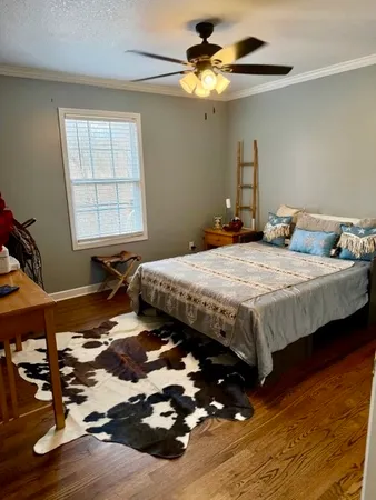 a bedroom with a bed and a chandelier