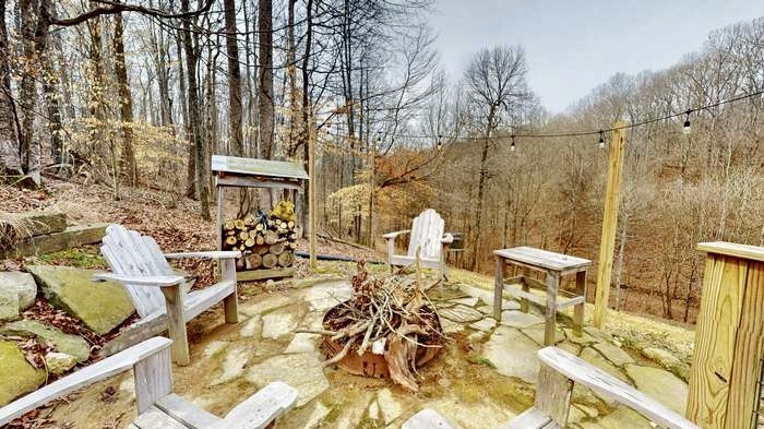 1198 Ed Sanders Road Lynchburg, TN 37352 - Photo 29 of 32 a view of a patio with table and chairs and wooden floor