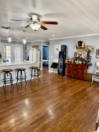 a living room with lots of furniture and wooden floors