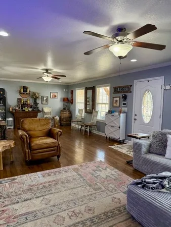 a living room with furniture and a chandelier