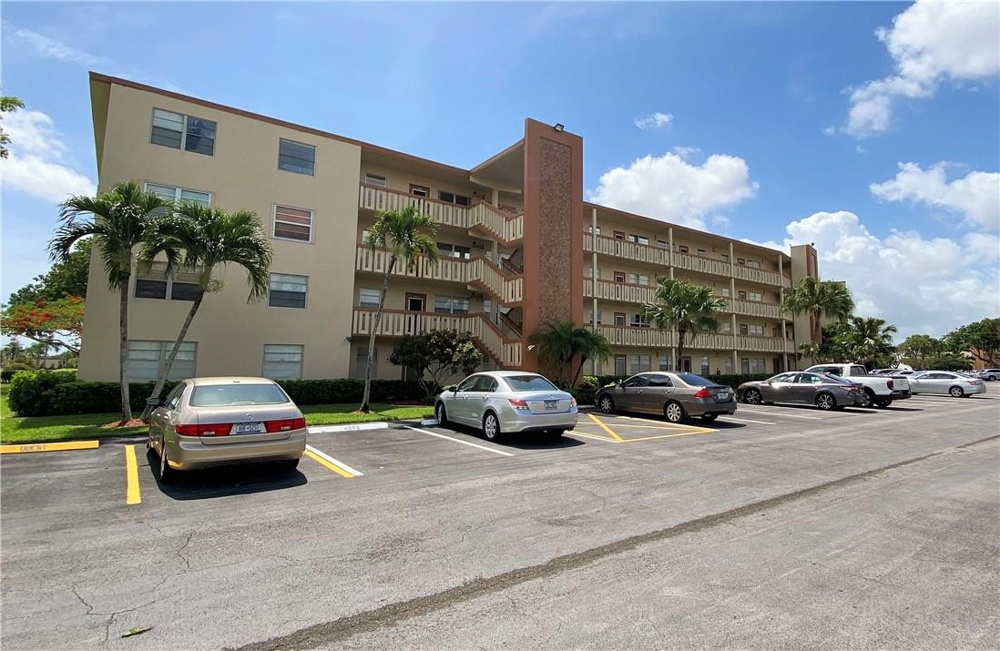 4055 Newcastle A, Unit 4055 Boca Raton, FL 33434 - Photo 1 of 23 a car parked in front of a building