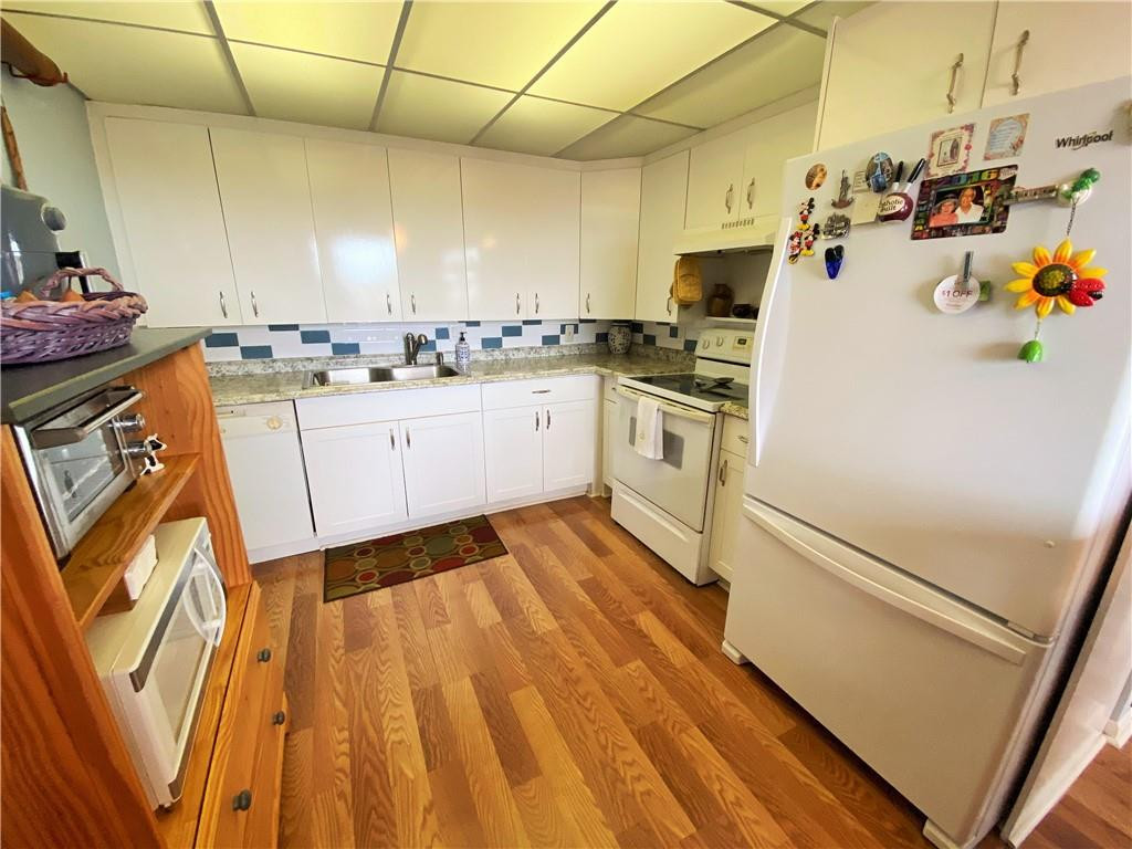 4055 Newcastle A, Unit 4055 Boca Raton, FL 33434 - Photo 16 of 23 a kitchen with a sink appliances and cabinets