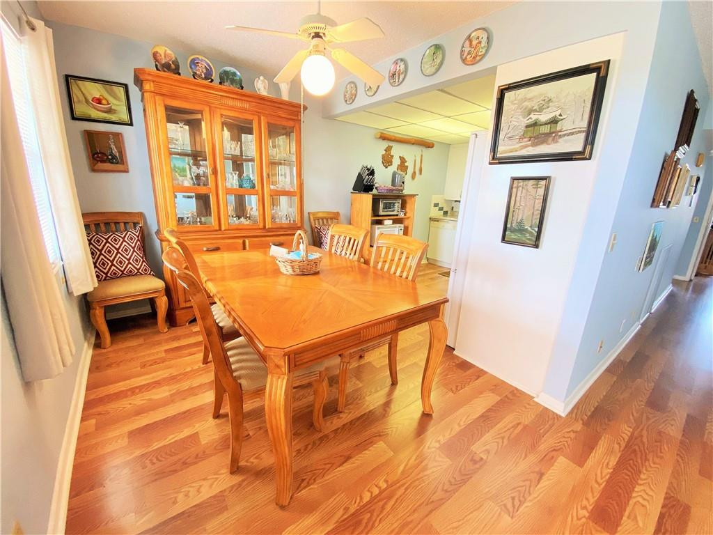 4055 Newcastle A, Unit 4055 Boca Raton, FL 33434 - Photo 18 of 23 a view of a dining room with furniture and wooden floor