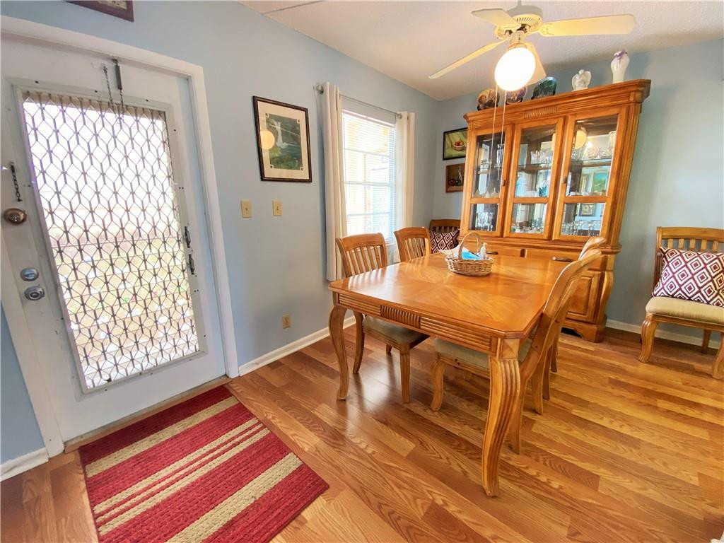 4055 Newcastle A, Unit 4055 Boca Raton, FL 33434 - Photo 19 of 23 a dining room with wooden floor and large window