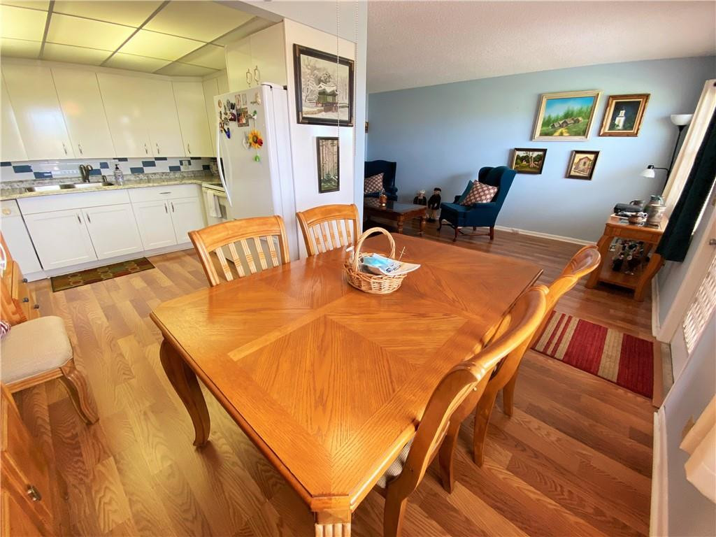4055 Newcastle A, Unit 4055 Boca Raton, FL 33434 - Photo 20 of 23 a bedroom with furniture and a wooden floor