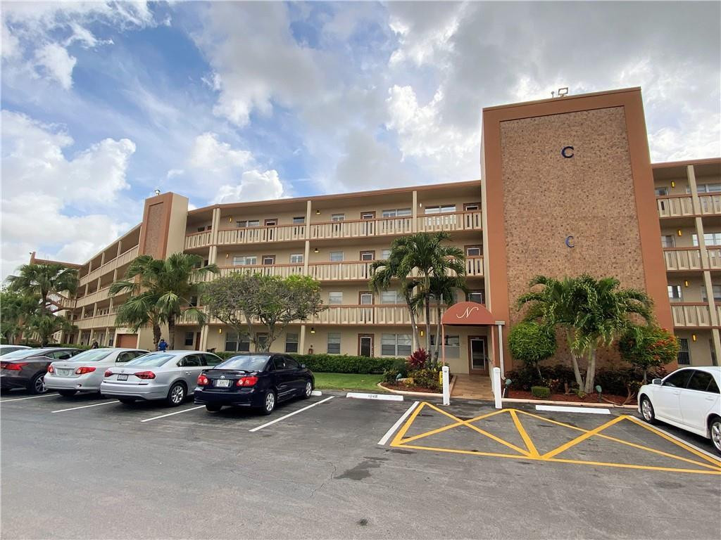 4055 Newcastle A, Unit 4055 Boca Raton, FL 33434 - Photo 2 of 23 a view of a cars park in front of house